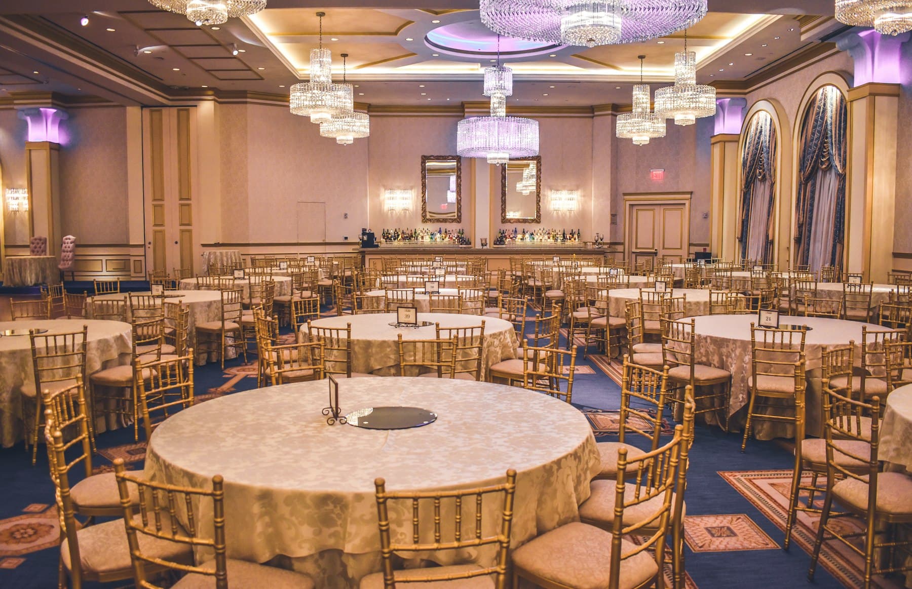 Chandelier-lit ballroom set for a wedding reception