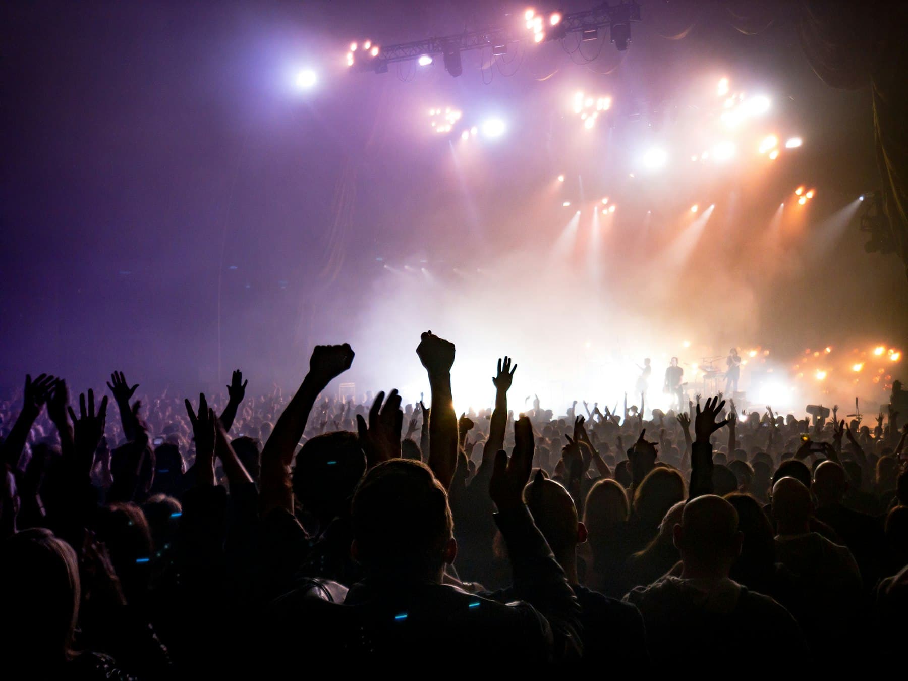 Stage lighting over a concert crowd